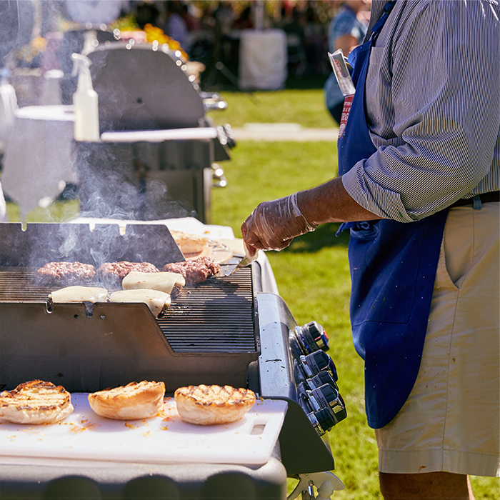 Tom Doyle cooking burgers on a grill